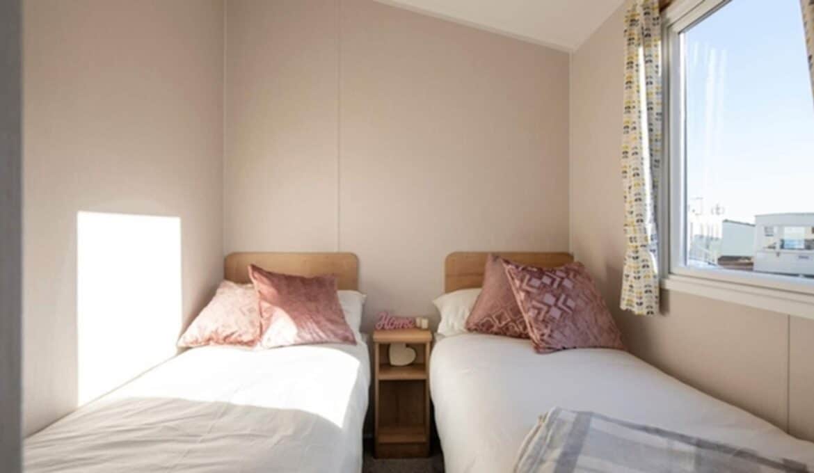 Twin bedroom with two single beds at The Beach holiday caravan